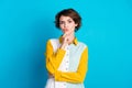 Photo of suspicious uncertain woman wear shirt arm chin looking you isolated blue color background Royalty Free Stock Photo