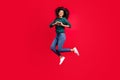 Photo of sweet charming dark skin woman dressed green pullover smiling showing fingers heart jumping isolated red color