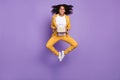 Photo of sweet charming lady wear yellow suit glasses smiling jumping high holding books isolated purple color Royalty Free Stock Photo