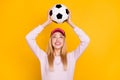Photo of sweet charming young lady wear pink sweater headwear smiling throwing looking ball isolated yellow color