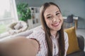 Photo of sweet cheerful young girl wear striped shirt tacking selfie showing room tour indoors apartment Royalty Free Stock Photo