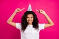 Photo of sweet curly young disco lady point cap wear white t-shirt isolated on pink color background