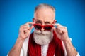 Photo of sweet doubtful mature man dressed white pullover arms red glasses isolated blue color background