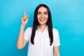 Photo of sweet excited girl dressed white shirt pointing finger having great idea isolated blue color background Royalty Free Stock Photo