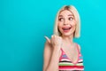 Photo of sweet excited lady wear striped singlet looking pointing thumb back empty space isolated turquoise color