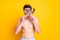 Photo of sweet excited young guy shirtless dressed mask ready dive isolated yellow color background