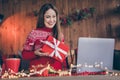 Photo of sweet funny young woman dressed red sweater having video call modern gadget holding new year gift smiling Royalty Free Stock Photo