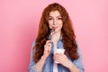 Photo of sweet hungry young woman wear denim shirt ready eat yogurt licking spoon smiling pink color background