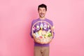 Photo of sweet impressed young man dressed purple pullover holding big easter bucket isolated pink color background