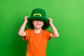 Photo of sweet lovely small kid boy prepare for saint patrick kindergarten occasion isolated green color background Royalty Free Stock Photo