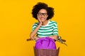 Photo of sweet millennial lady drive bicycle wear glasses green t-shirt bag isolated on yellow background Royalty Free Stock Photo