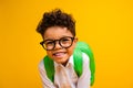 Photo of sweet positive schoolboy beaming smile good mood carry backpack isolated on yellow color background Royalty Free Stock Photo