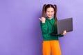 Photo of sweet pretty little girl dressed green hoody texting modern gadget thumb empty space isolated purple color Royalty Free Stock Photo