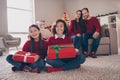 Photo of sweet pretty son daughter dad mom wear red pullovers smiling hugging holding christmas gifts indoors house home Royalty Free Stock Photo