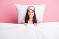 Photo of sweet pretty young woman sleepwear mask lying pillow covering duvet isolated pink color background