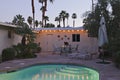 Swimming pool with chaise lounge in evening lights Royalty Free Stock Photo