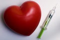 Syringe and a red blood stain in heart shape