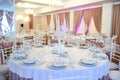 photo of a table in a banquet hall in white and brown colors decorated for the event Royalty Free Stock Photo