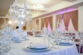 photo of a table in a banquet hall in white and brown colors decorated for the event Royalty Free Stock Photo