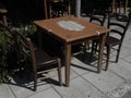 Table with details and chairs in retro style in pub on promenade