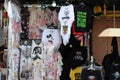 An assortment of tee shirts and dresses with different theme design and colors on display for sale