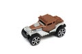 A Brown classic vintage old design toy car with modern open pipes and side exhaust pipes and a skull head at the front