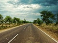 Empty highway image with a dramatic sky above