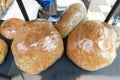 A few large rounded shrink wrapped bread buns on display