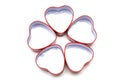 Five heart shaped metal containers arranged in a petal pattern Royalty Free Stock Photo