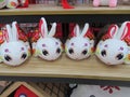 Four identical similar white auspicious rabbit soft toys on display