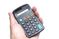 A hand holding a basic black plastic housing scientific calculator powered by battery and solar power