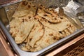 A large open tray of Indian Naan leavened oven baked flatbread