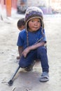 little Tibetan boy with his simple and crude toy , Upper Mustang trekking, Nepal. Royalty Free Stock Photo