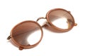 A pair of brown sun shade spectacles glasses against a white backdrop