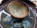 A pair of colorful ceramic clay bowl and plate on display