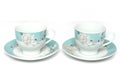 A pair of light colored teacups with saucers Royalty Free Stock Photo