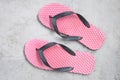 A pair of pink slippers shoes laid out on a concrete floor Royalty Free Stock Photo