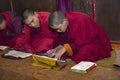hard working Bhutanese novice monks learning the Buddhism text in early morning , Bhutan