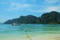 Photo is taken at Phuket, Thailand. Scene is Ocean, buoy, mountain, blue sky, speed boat. It is summer time in Thailand.