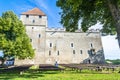 A man sits by the benches at Kuressaare Castle