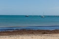 A photo taken on a spring day at Swanage beach looking towards the boats on the sea