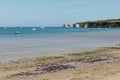 A photo taken on a spring day at Swanage beach looking towards the boats on the sea and the jurasic coast line