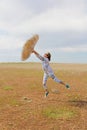 Photo taken in summer. The girl jumps and depicts weightlessness