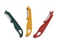 Three straight fruit vegetable skin peelers - bright red yellow and olive green