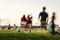 Blurred Motion of People Walking Across a Park to an Outdoor Concert