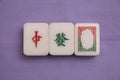 Top down view of a set of Mah Jong pieces showing all three dragons