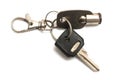 A tubular and a mechanical cut keys held by a keyring white backdrop Royalty Free Stock Photo