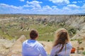 Young couple admiring the scenery of the mountains of Cappadocia