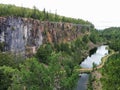 Beautiful Rock Face with Lake and Suspension Bridge Royalty Free Stock Photo