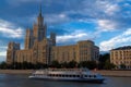 Photo of a tall building standing on the bank of the Moskva River at sunset